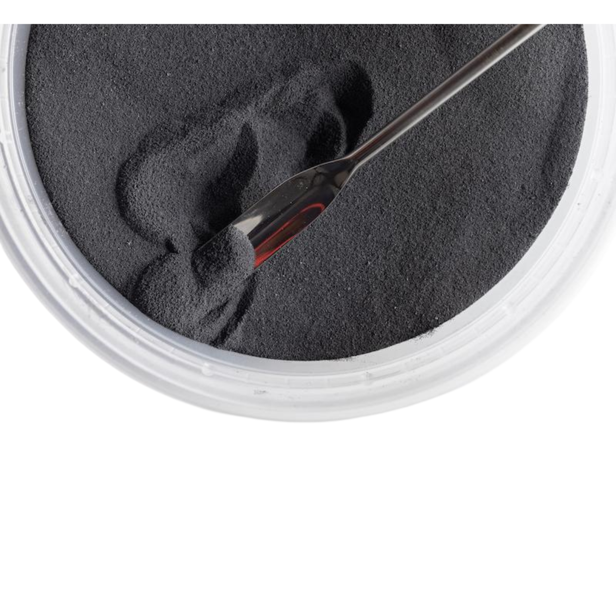 Bowl filled with dark gray polymer powder.