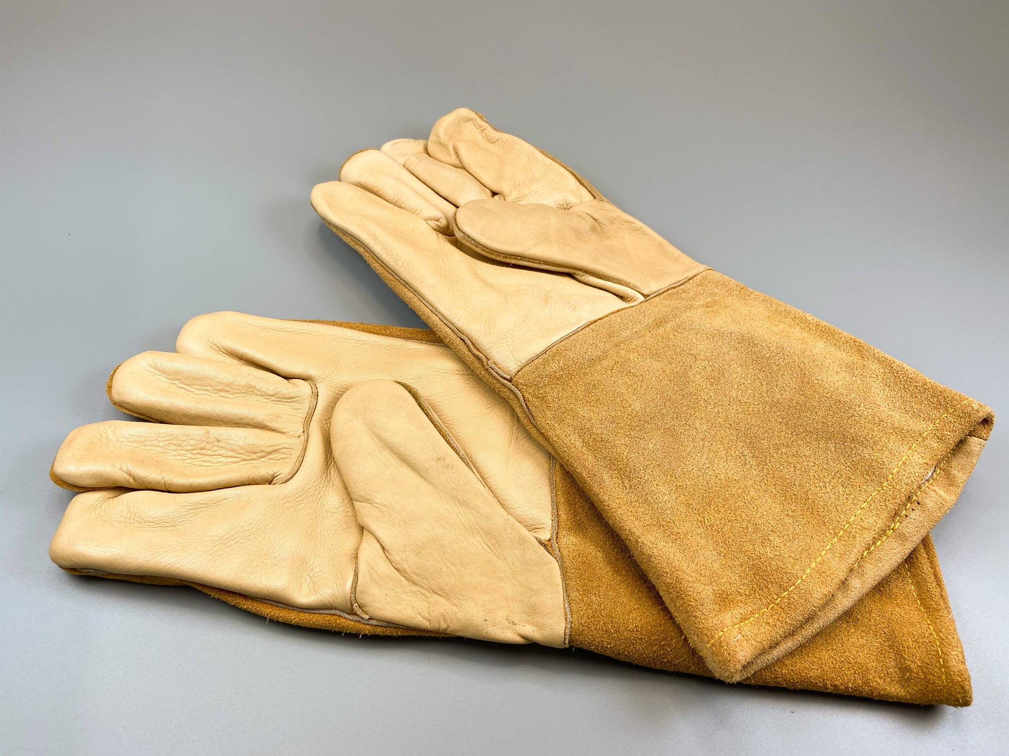 A pair of brown welding gloves.