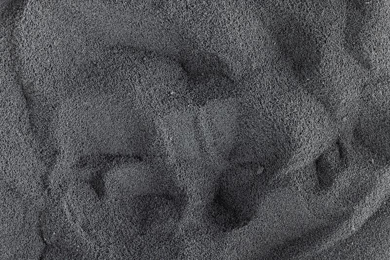 Detailed view of dark gray polymer powder.