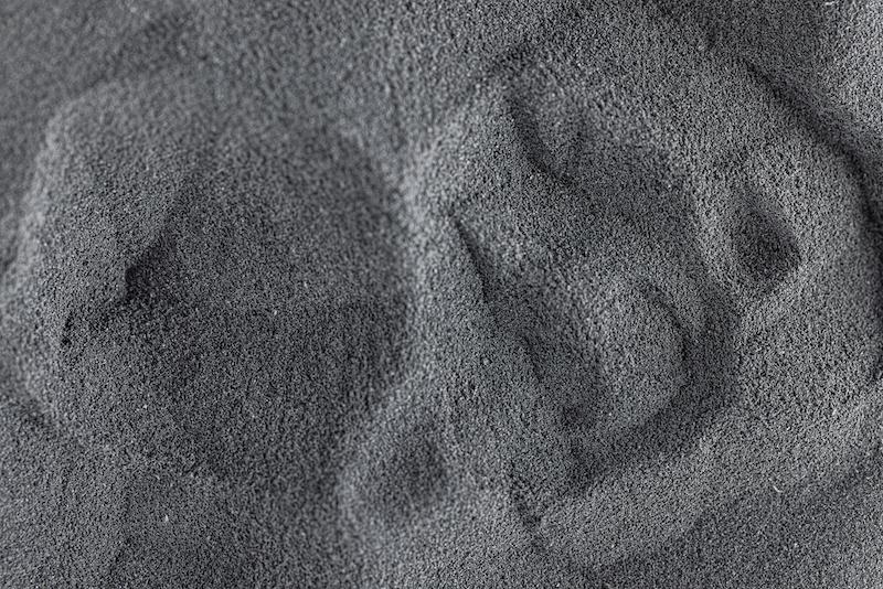 Close up of dark gray polymer powder.