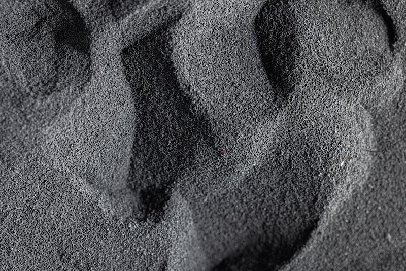 Close up of dark gray polymer powder.