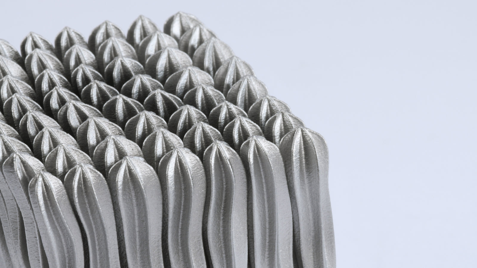 Metallic gray part made of aluminium.