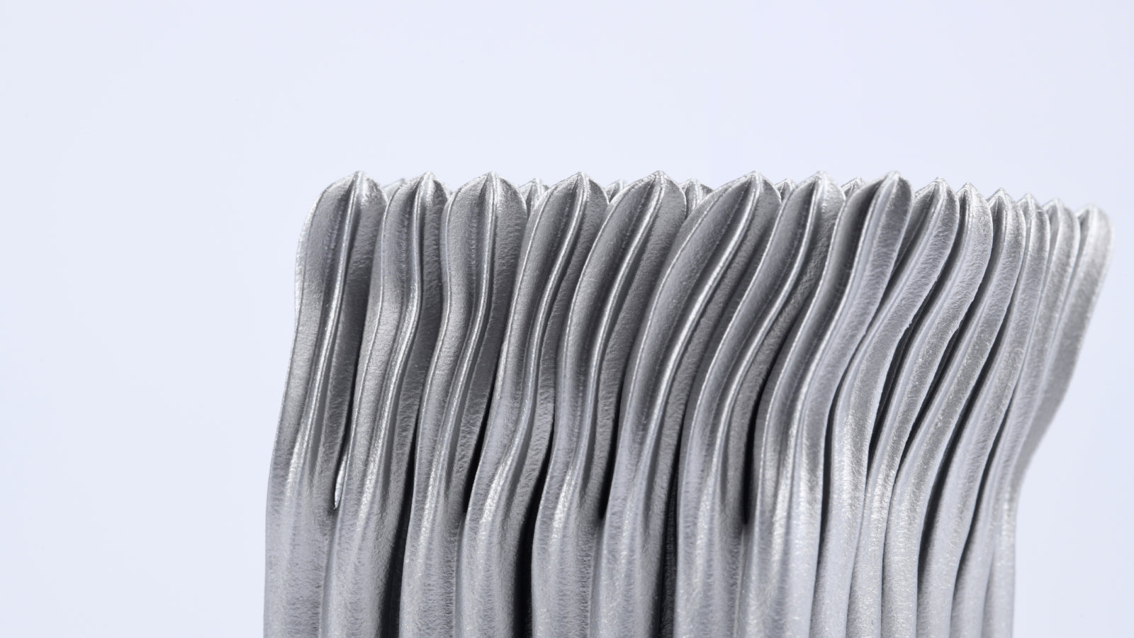 Metallic gray part made of aluminium.