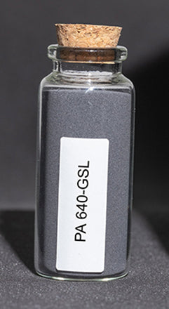 Glass bottle filled with dark gray polymer powder.