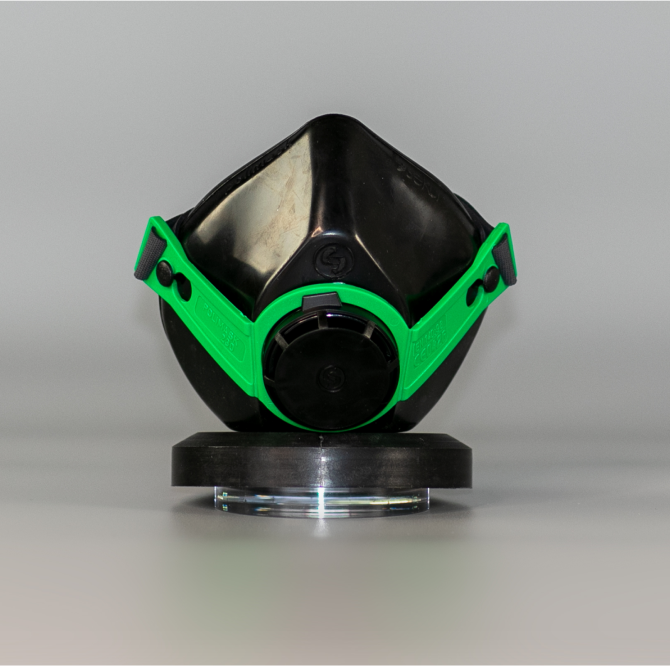 Front view of a black and green protective mask.