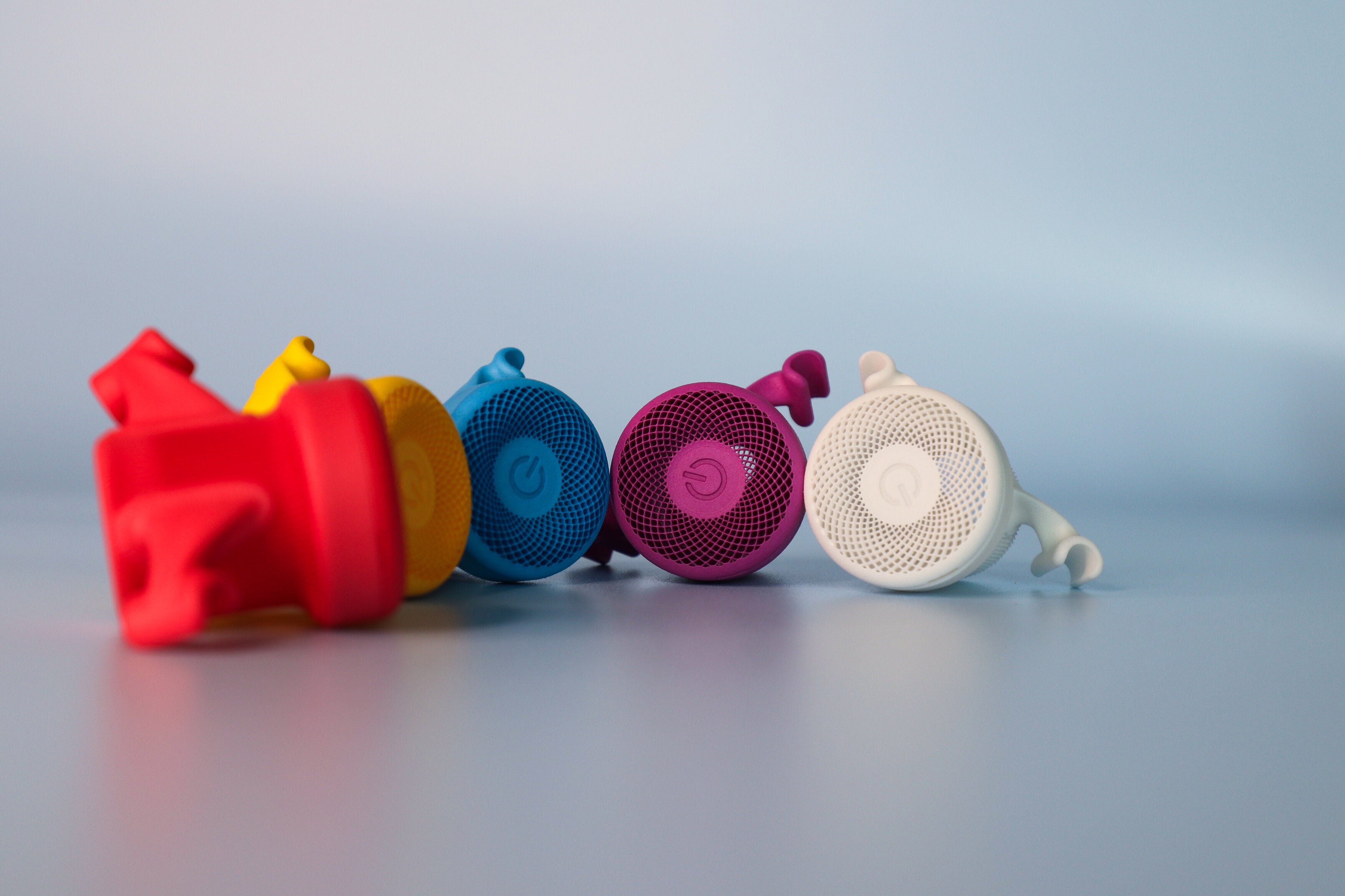 Small parts in different colors 3d printed with a polymer material.