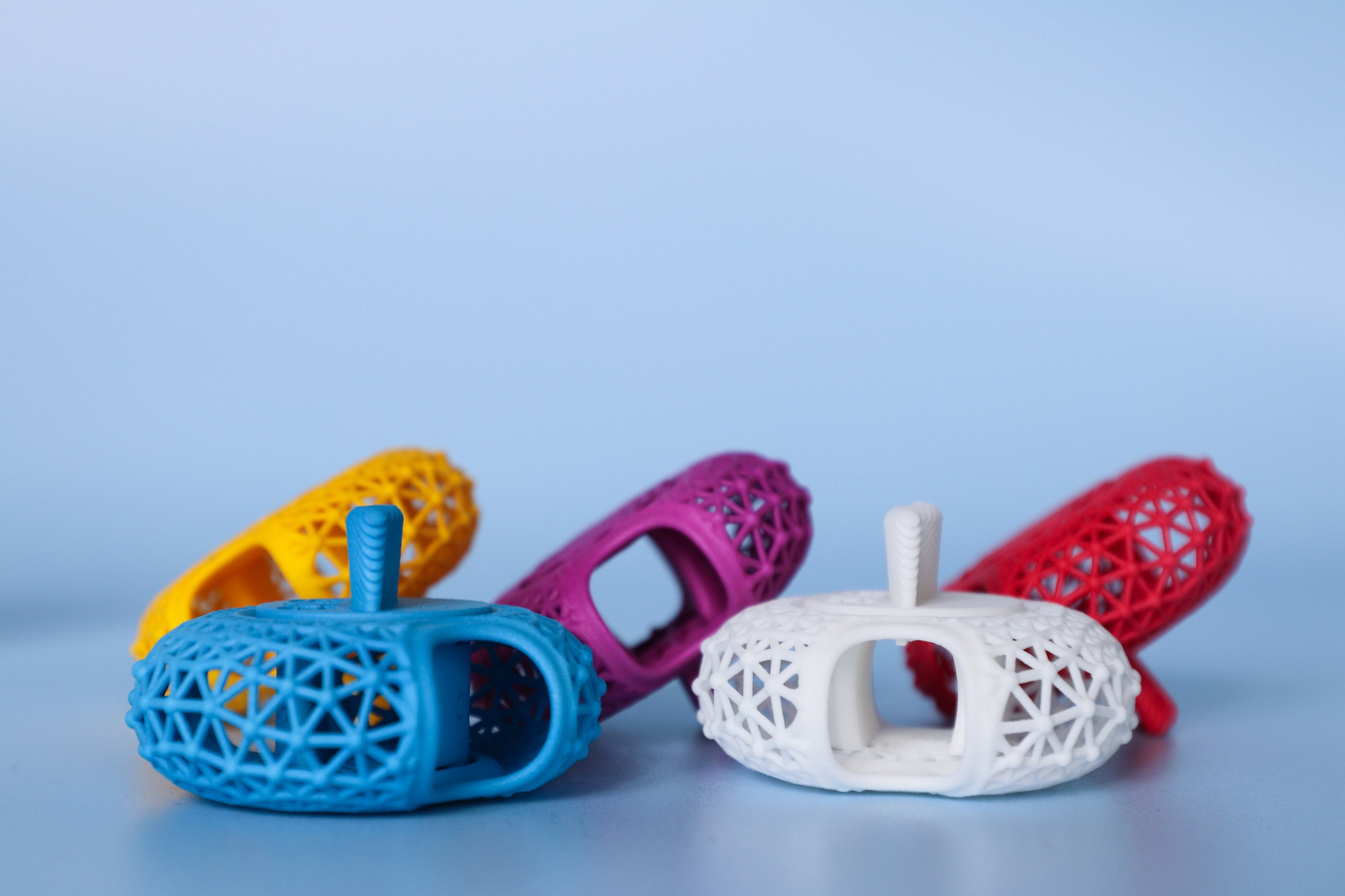 Small parts in different colors 3d printed with a polymer material.